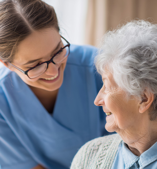 two women engaged in conversation smiling together showcasing professional interaction