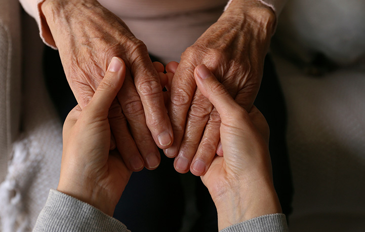 hands of two people gently holding each other depicting connection and support through touch